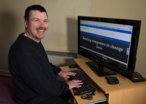 David, one of our clients, with his computer